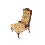 An Edwardian carved walnut nursing chair