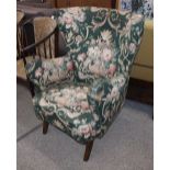 A mid-20th Century continental wing back easy chair, upholstered in