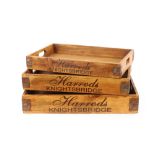 A set of three graduated wooden trays, printed H