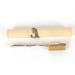 A faux ivory cased silver travelling toothbrush