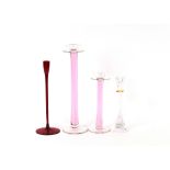Two graduated pink tinted glass candlesticks; a ru