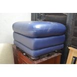 A blue upholstered pouffe