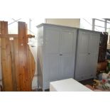 A grey painted two door wardrobe fitted two drawer