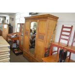 A late Victorian ash triple wardrobe fitted two dr