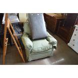 A green upholstered deep seated armchair