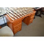 A pine kneehole dressing table fitted six drawers