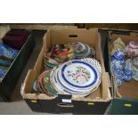 A box of various decorative plates