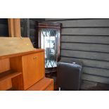 A reproduction mahogany and glazed corner cabinet