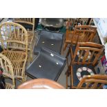 A pair of black upholstered kitchen stools