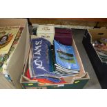 A box containing various car books, beer towels et