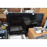 A Toshiba flat screen televison with remote contro