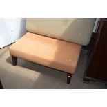 A button down upholstered foot stool