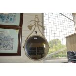 A circular decorative wall mirror