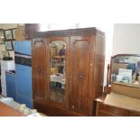 An oak triple wardrobe fitted two drawers below