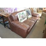 A brown leather upholstered three seater settee