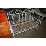 A white painted metal folding garden bench