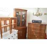 A reproduction glazed corner cabinet