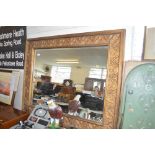 A large gilt framed bevel edged wall mirror