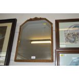 A bevel edged wall mirror contained in gilt frame