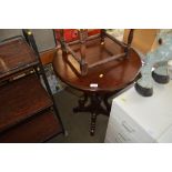 A reproduction mahogany circular topped table