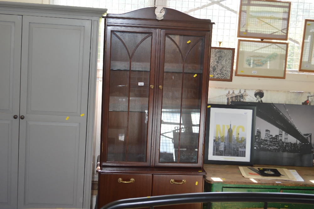 A reproduction mahogany display case raised of cup