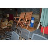 A teak garden table; and two chairs