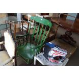 A green painted slat back rocking chair