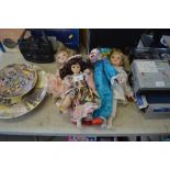 Three dressed dolls and a clown