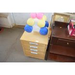 A wooden four drawer filing chest