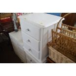 A pair of white painted pine bedside chests fitted