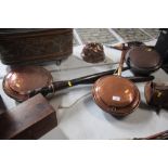 A Victorian copper warming pan with turned wooden