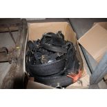 A box containing various bridles, horse collars etc.