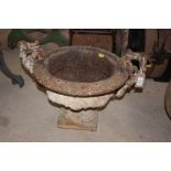 An antique cast iron campana shaped garden urn