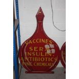 A chemists hardwood advertising sign, bottle shaped 123cm high