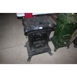 A cast iron enamel decorated stove, having pierced