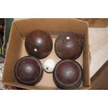 A set of four Lignum Vitae bowling woods and a ch