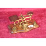 A set of brass postal scales and weights