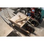 A vintage wooden wheelbarrow, having original spok