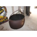 An old cast iron cauldron with swing handle