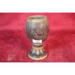 An antique carved coconut and horn mounted beaker,