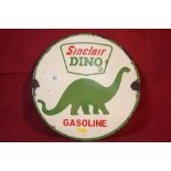 A circular "Sinclair Dino Gasoline" advertising sign