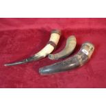An antique cow horn with scrimshaw work decoration