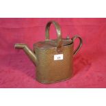 A spot hammered brass watering can
