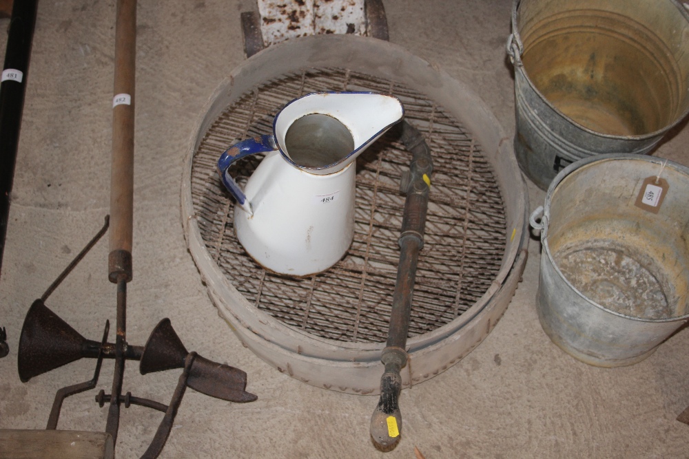 Two vintage soil sieves; a brass garden sprayer a