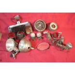 A collection of various vintage car lights, clocks