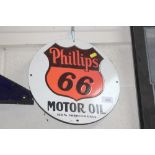 A circular enamel advertising sign for "Phillips M