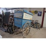 A Scotties Bakery wooden hand delivery cart on ori