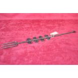 An antique iron toasting fork