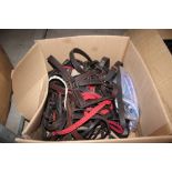 A box of various bridles etc.