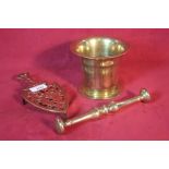 An antique brass pestle and mortar and a pierced
